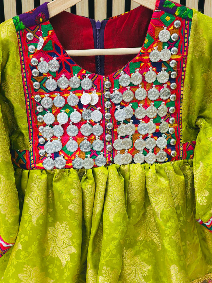 Girls’ Afghan tribal dress in green with coins, hand embroidery, and geometric patterns