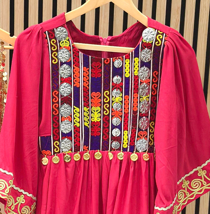 Handmade Afghani girls’ dress in pink with cultural embroidery and tribal Afghan design