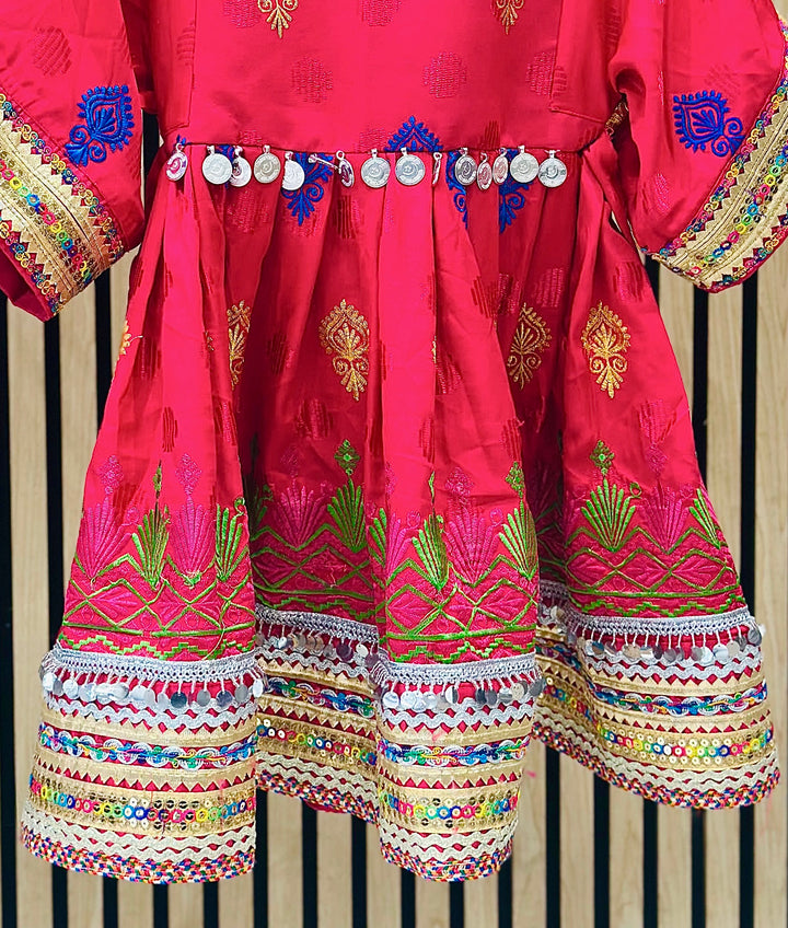 Afghan Kuchi style girls dress in pink and blue with intricate embroidery