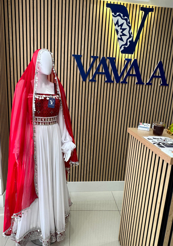 Mannequin wearing a red and white traditional outfit with a 'VAVA' logo in the background.