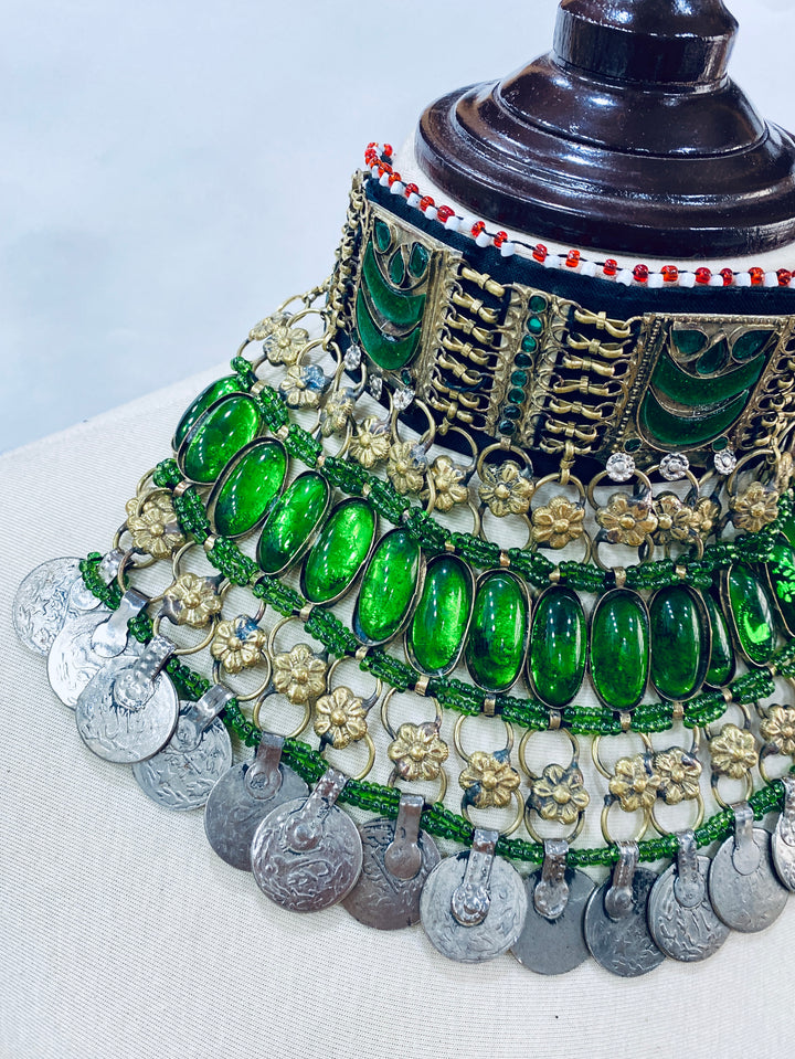 Tribal jewellery piece with green gemstones and gold accents