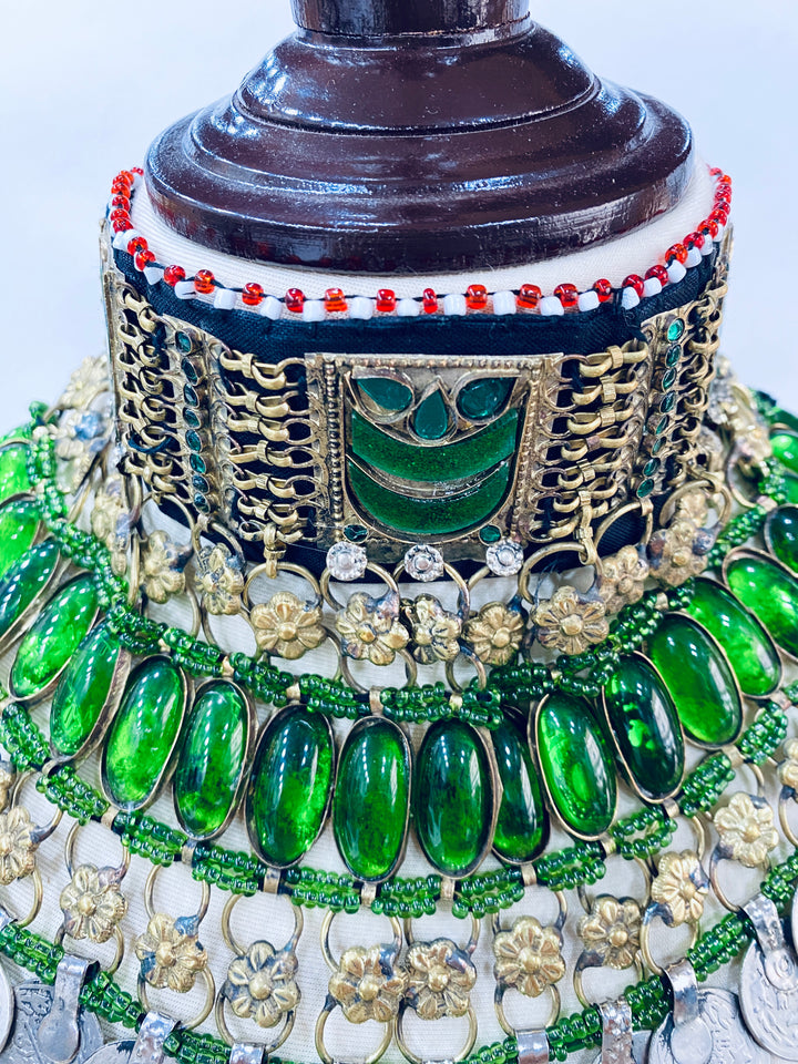 Traditional necklace with gold-plated design and green gemstones
