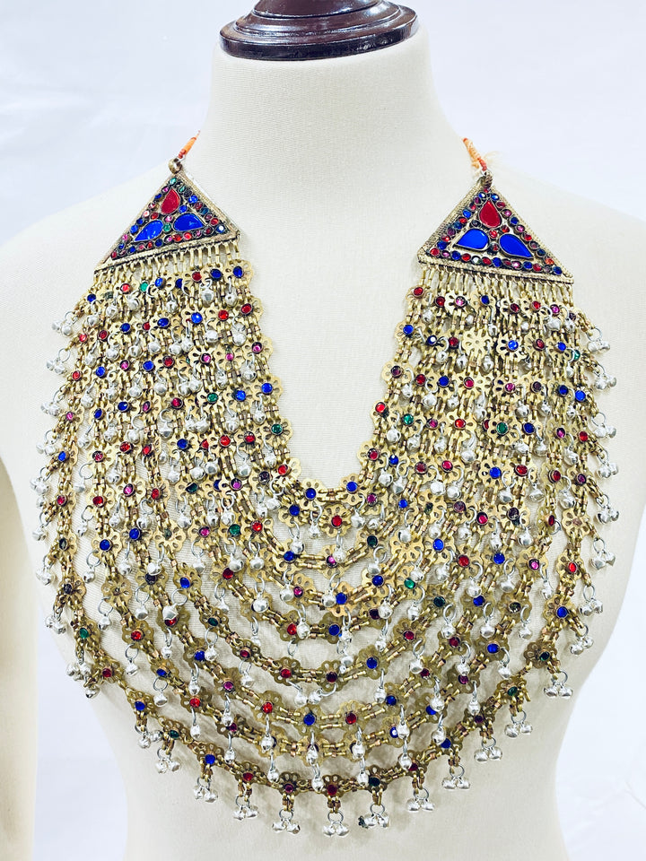 Decorative necklace with multicolored stones on a mannequin against a white background