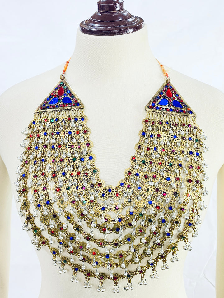 Decorative necklace with multicolored stones on a mannequin against a white background
