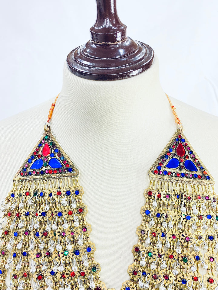 Decorative top with colorful gemstones on a mannequin against a white background
