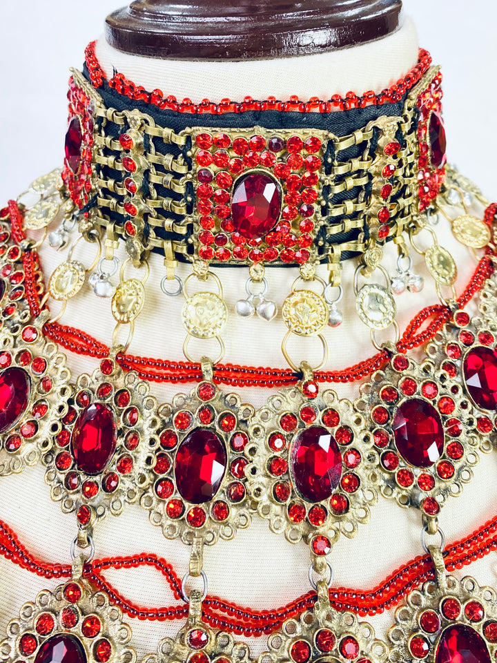 Ornate necklace with red gemstones on a mannequin