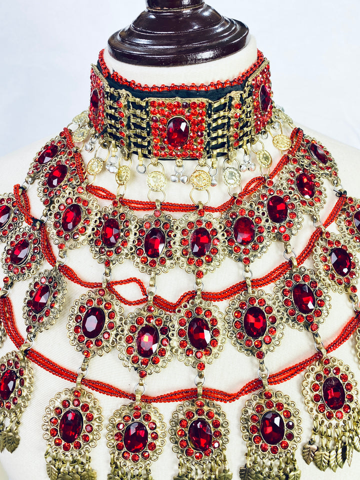 Ornate necklace with red gemstones on a mannequin