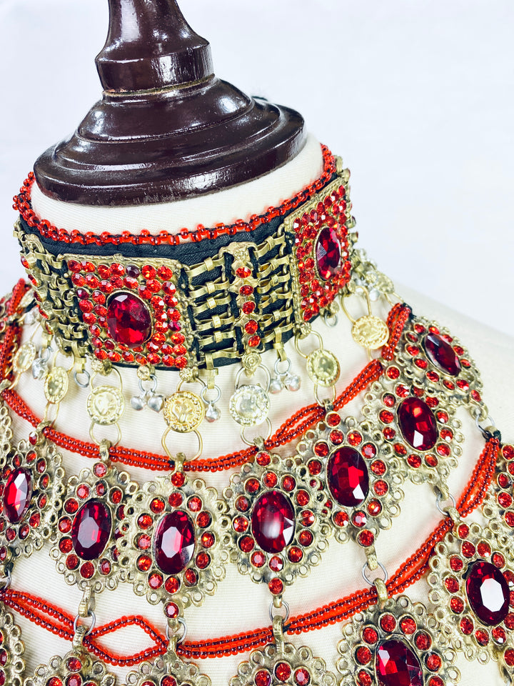 Ornate jewelry set with red gemstones on a mannequin near me
