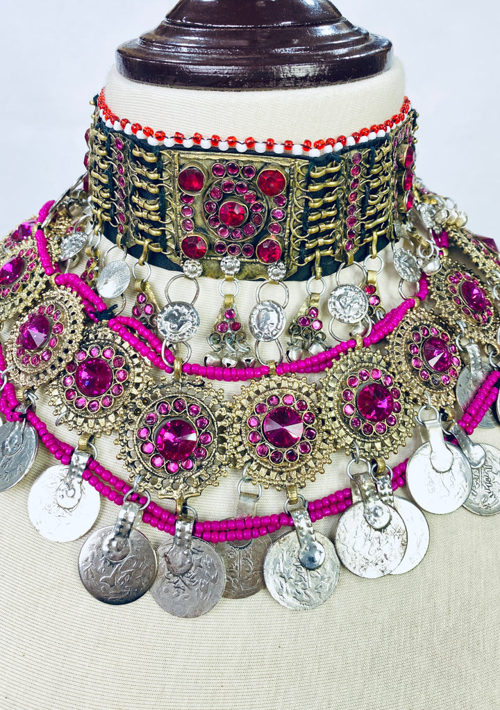 Ornate necklace with pink and silver details on a mannequin bust.