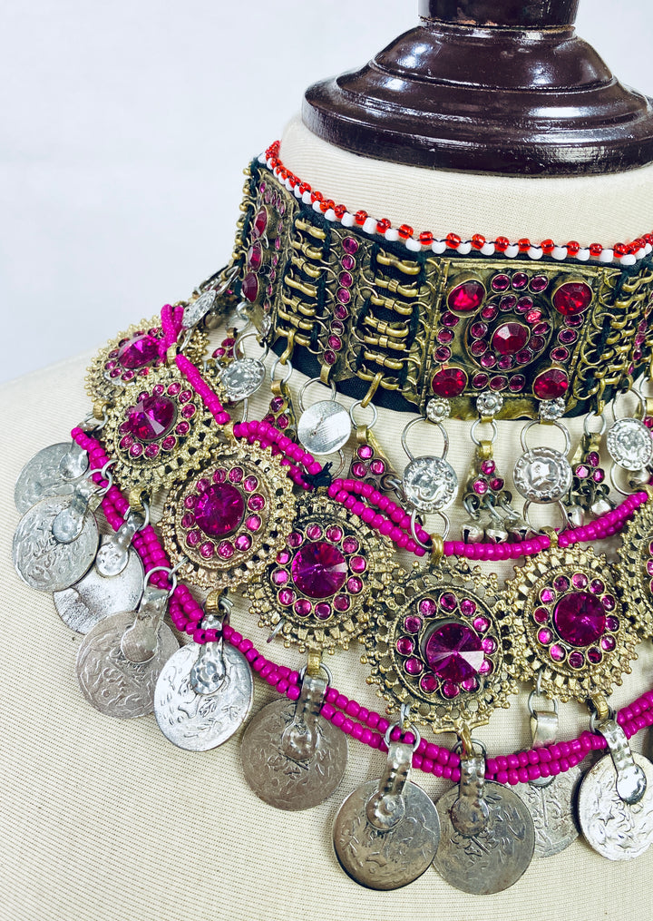 Decorative necklace with pink and silver elements on a white background