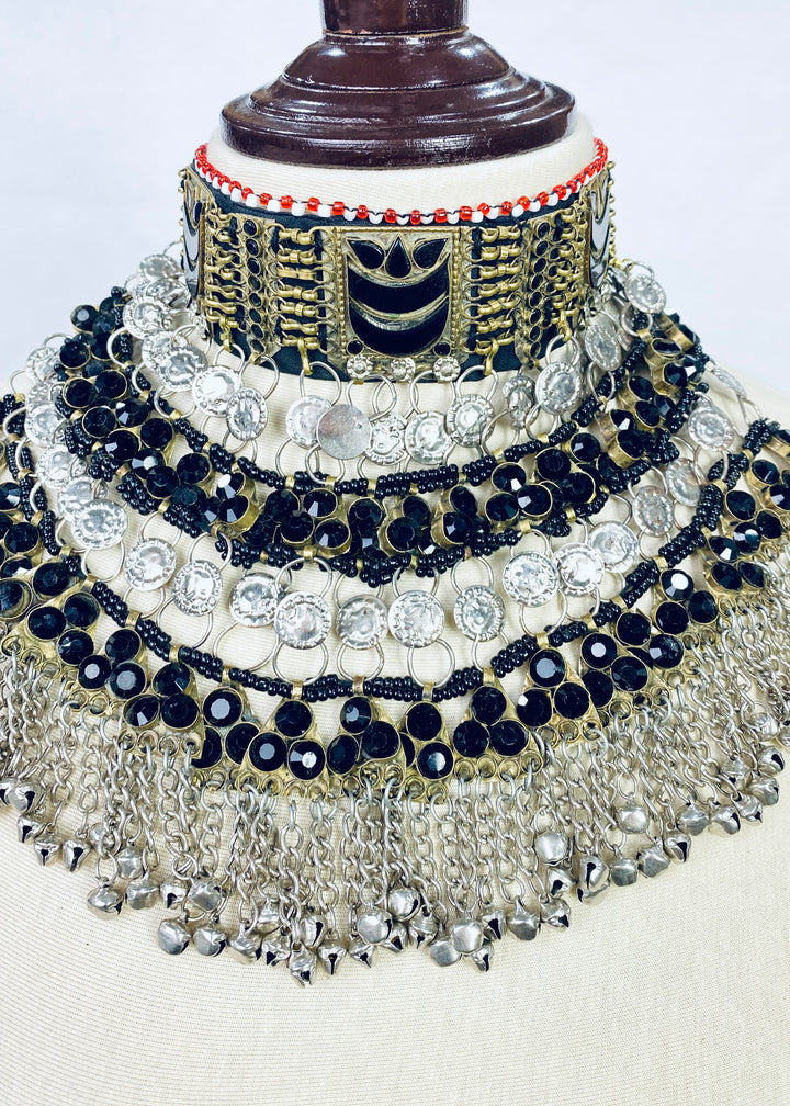 Decorative jewelry set with black, gold, and silver elements on a white background