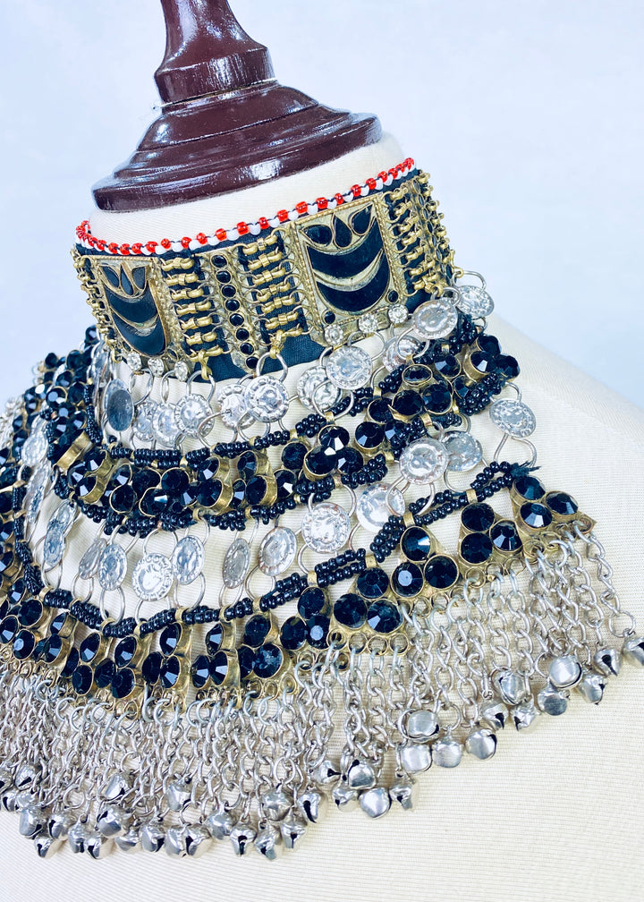 Decorative headpiece with blue, gold, and silver embellishments on a mannequin.