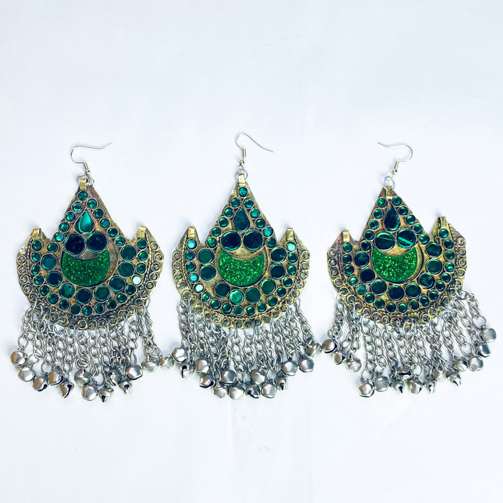 Set of three green, gold and silver earrings on a white background