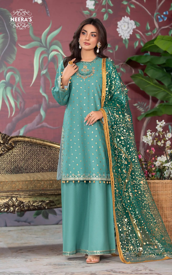 Woman wearing a green embroidered kameez shalwar with sequin and foil printed dupatta near me available at Vavaa outlet in UK near me.