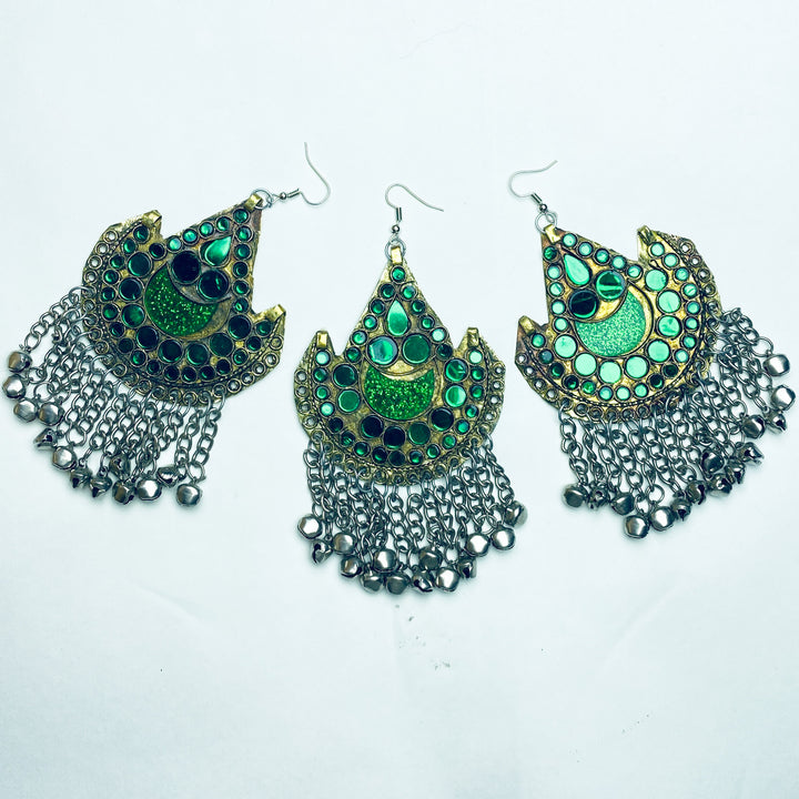 Three pairs of green, gold and silver earrings on a white background