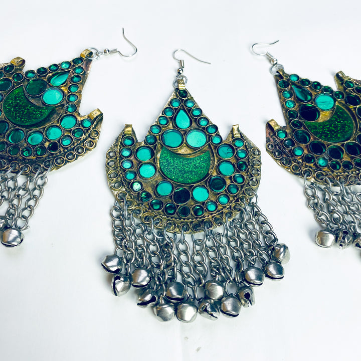 Three pairs of green, gold and silver earrings on a white background