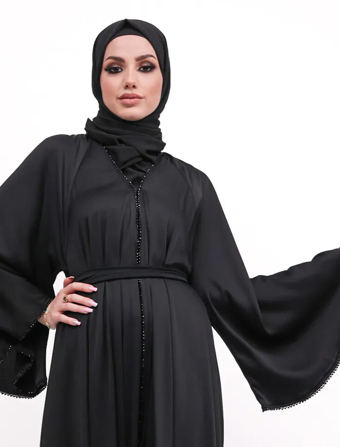 Makeba Pearl Abaya in luxurious satin with umbrella cut and black diamond accents, perfect for weddings and formal events. Shop abayas near me in the UK.