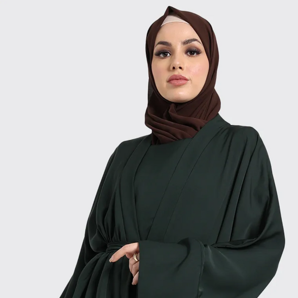 Woman wearing green two-piece simple abaya by Vavaa near me
