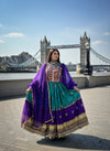 Woman in traditional afghani outfit with Tower Bridge in the background