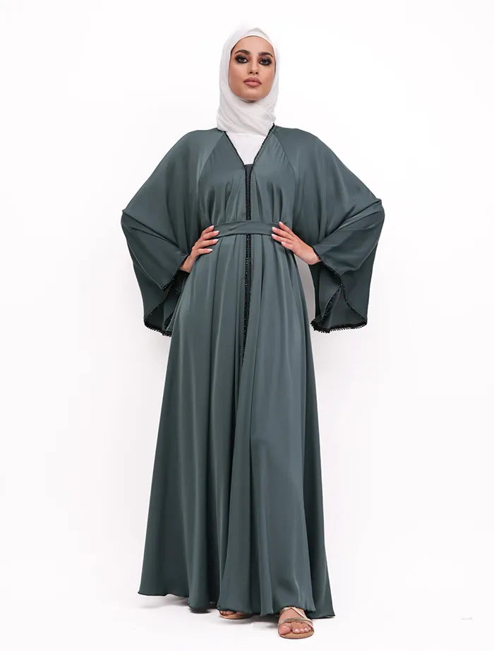 Shop the Makeba Pearl Abaya near me with luxurious satin fabric, black detailing, and full-flare design. Available for sale in the United Kingdom.