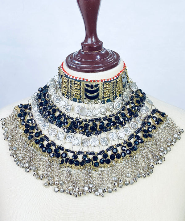 Decorative necklace with blue and silver stones on a mannequin head against a white background